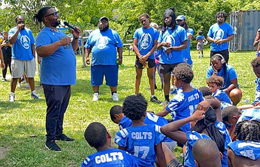 Bobby Christian addressing Eastside Colts players on the field