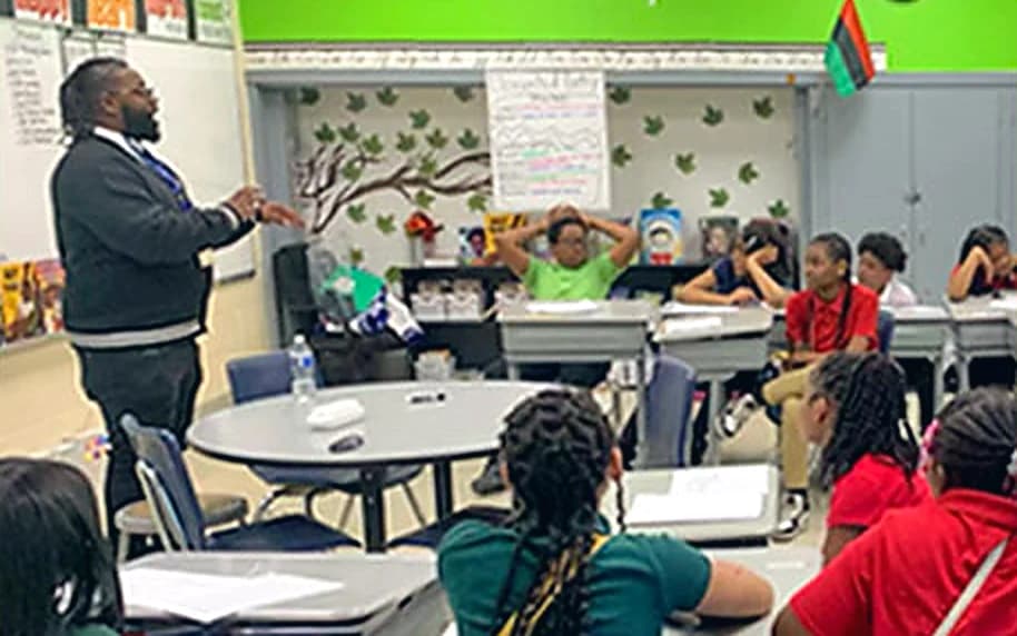 Bobby Christian speaking with students in a Detroit classroom